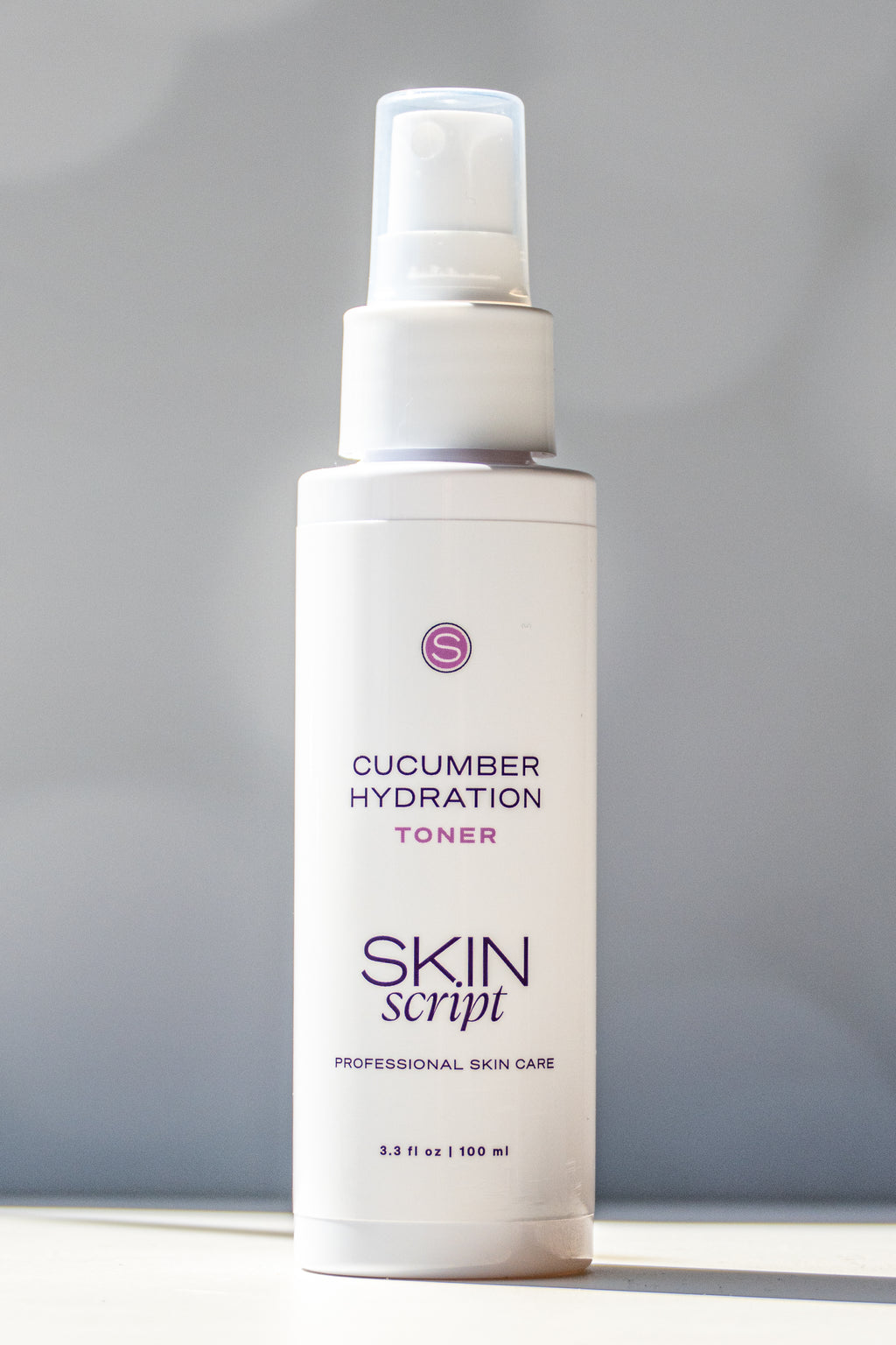 Skincare toner bottle labeled 'Cucumber Hydration Toner' by 'Skin Script' on a gray background